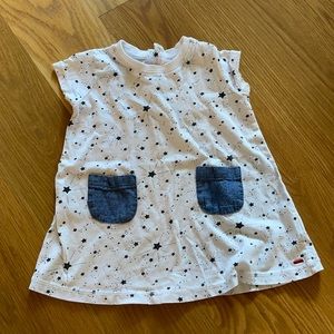 White dress with black stars and denim pockets.